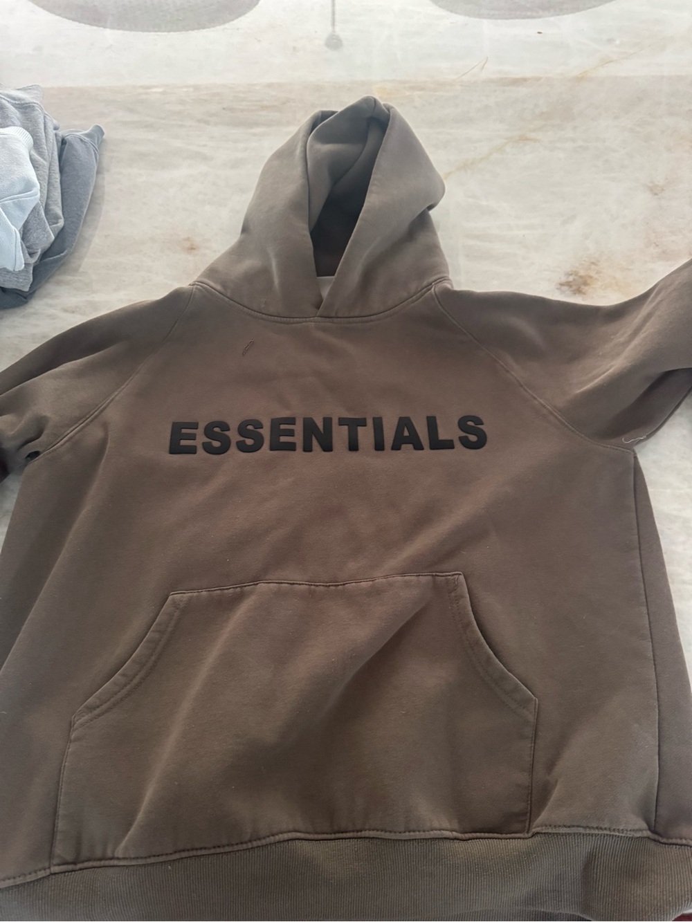 Essentials Men's Crewneck Hoodie in Olive Brown with Black Logo.